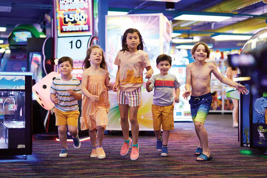Children having a blast at the Castaway Bay Gamer's Grotto Arcade